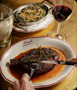 Dry-aged côte de boeuf and red wine at the AI Edge Table dinner