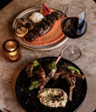Hearth-roasted lamb and red wine at the AI Edge Table dinner