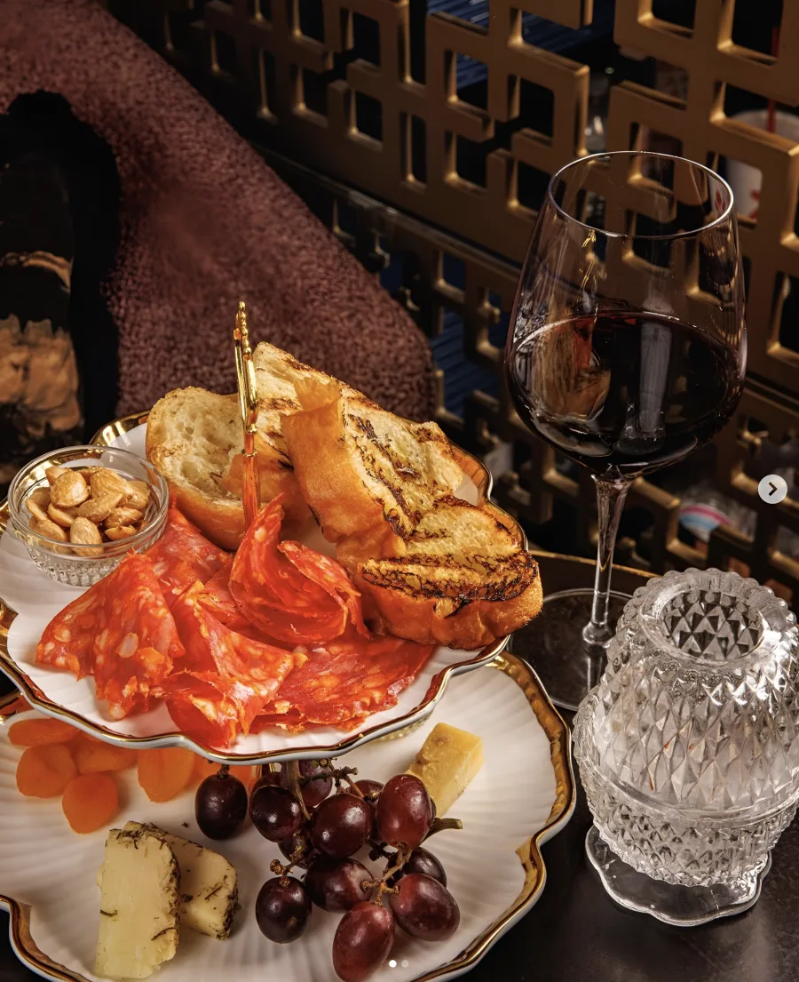 A charcuterie board and red wine at the AI Edge Table dinner