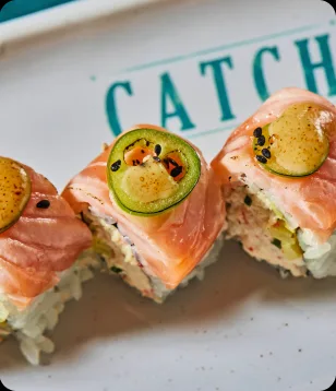 Salmon rolls topped with jalapeño at Catch LA