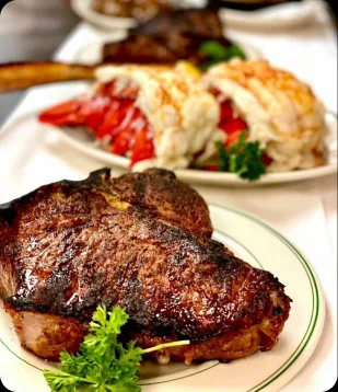 Dry-aged steaks carved tableside at the AI Edge Table dinner