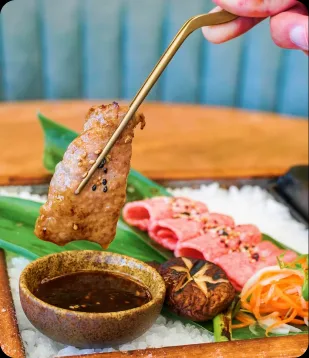A slice of wagyu lifted from the sushi platter at Catch LA