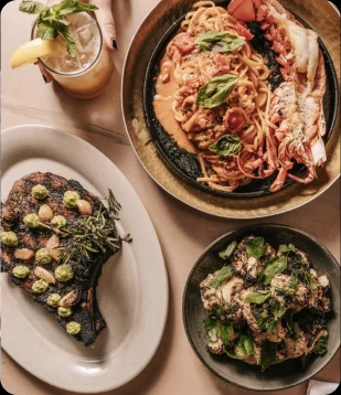 Whole grilled fish and charred greens at LÝRA, Chicago