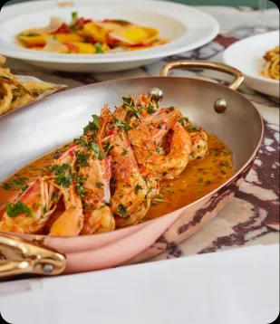 Prawns served in a copper pan at Daphne's