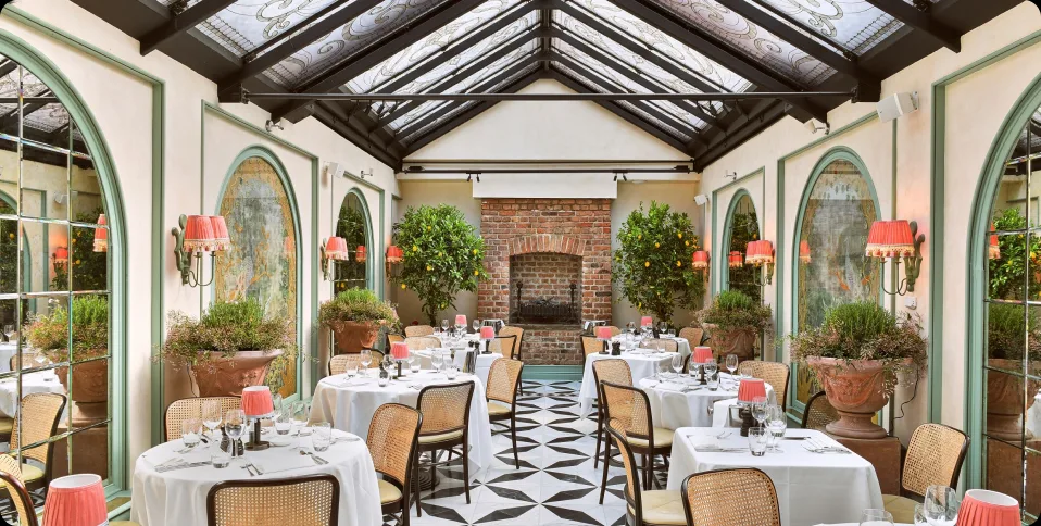 The glass-roofed Conservatory private dining room at Daphne's, London
